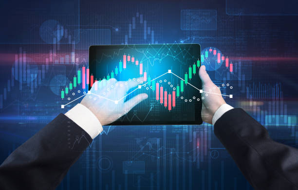 istock Hand holding tablet with global reports and stock market change concept 1183231168