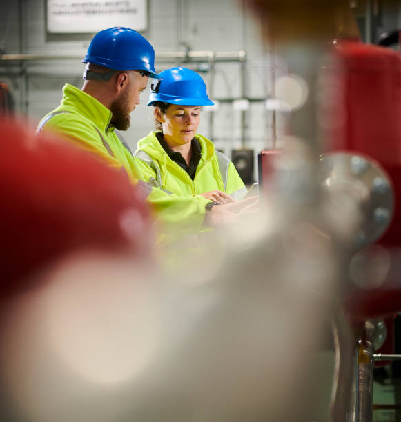 istock maintenance engineers in boiler room 1183233618