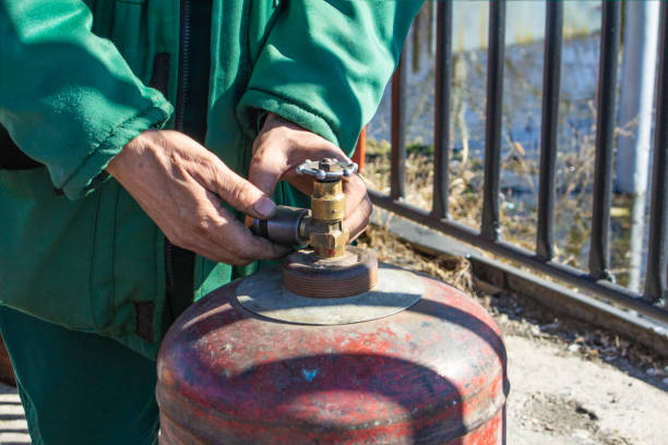 istock the working man has controlled gas cylinder propane closeup, the background is blurred with bokeh effect 1183233818