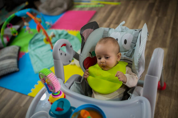 istock small child sits on a chair and eating with spoon 1183237863