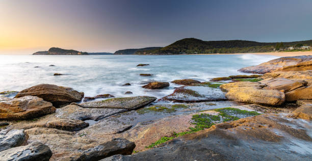 istock Clear Skies Rocky Sunrise Seascape 1183237966