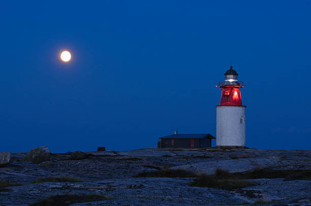 istock Lihgthouse at night with full moon behind 118324377