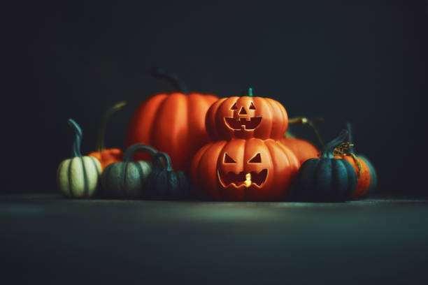 istock Halloween background with Jack O'Lantern and pumpkins 1183244482