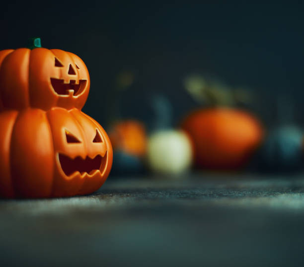 istock Halloween background with Jack O'Lantern and pumpkins 1183244484