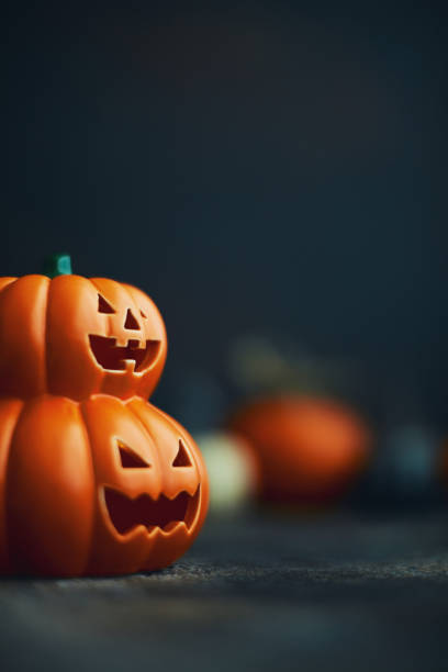 istock Halloween background with Jack O'Lantern and pumpkins 1183244485