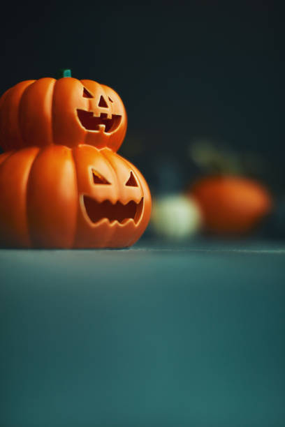 istock Halloween background with Jack O'Lantern and pumpkins 1183244511