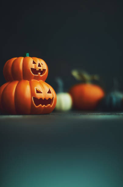 istock Halloween background with Jack O'Lantern and pumpkins 1183244517