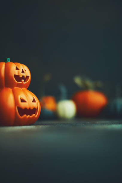 istock Halloween background with Jack O'Lantern and pumpkins 1183244518