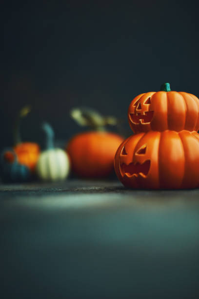 istock Halloween background with Jack O'Lantern and pumpkins 1183244539
