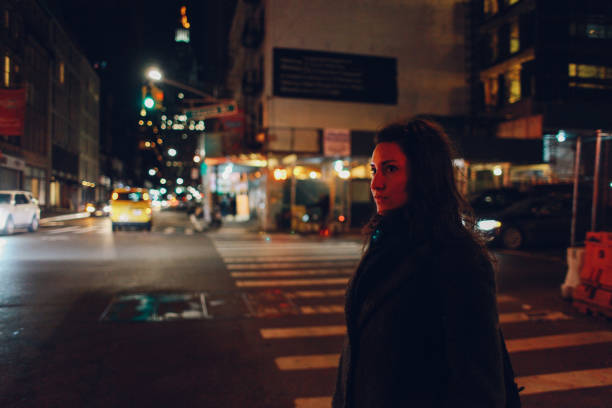 istock walking alone in New York City at night 1183245182
