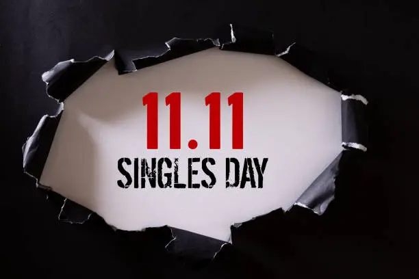 Online shopping of China, 11.11 singles day sale concept. Top view of Black torn paper and the text 11.11 singles day sale on a white background.