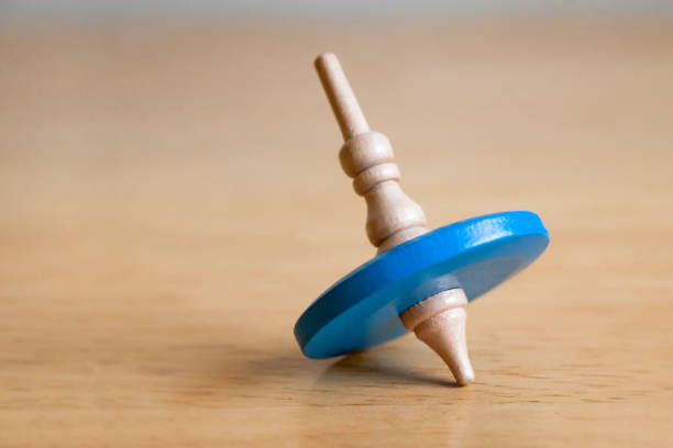 istock blue wooden top toy on a table 1183246278