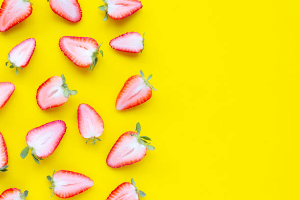 istock Ripe strawberries on yellow background. 1183247413