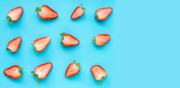 istock Ripe strawberries on blue background. 1183247428