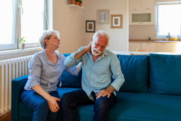 istock Senior lady comforting his husband with headache 1183250428