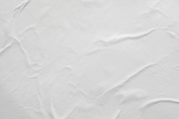 istock Blank white crumpled and creased paper poster texture background 1183253445