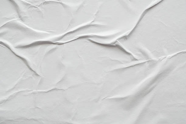 istock Blank white crumpled and creased paper poster texture background 1183253446