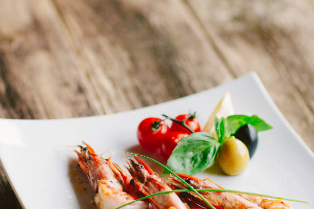 istock culinary master class grilled tiger prawns olives 1183253522