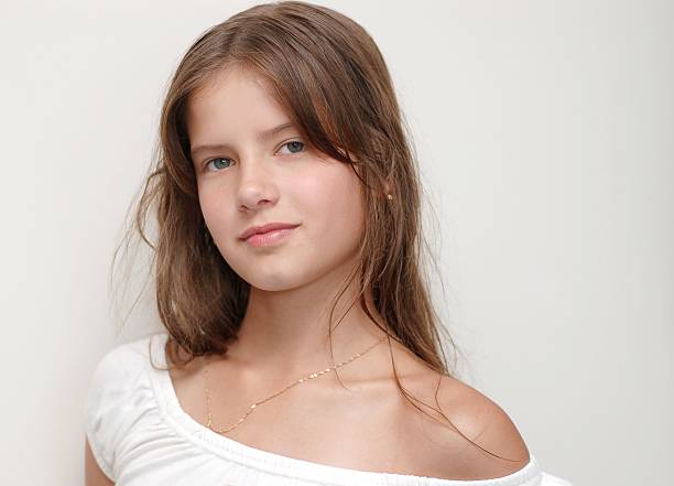 Blonde girl in summer dress in studio.