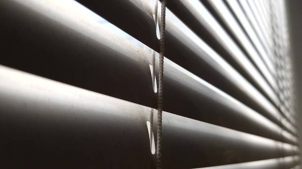 istock Dirty closed blinds and rope macro view. Jalousie background 1183254304