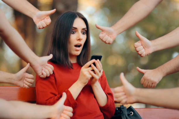 Woman Getting Appreciation on Her Social Media Posts Happy female online influencer getting positive feedback internet fame stock pictures, royalty-free photos & images