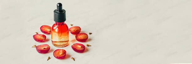 istock Grape seed oil. Creative still life of grapes, seeds and a bottle on a light background. Flat lay. Banner 1183261977
