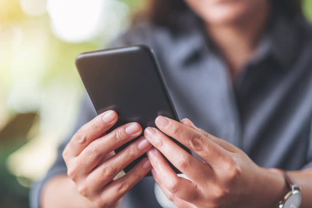 istock a woman holding  and using mobile phone 1183279349