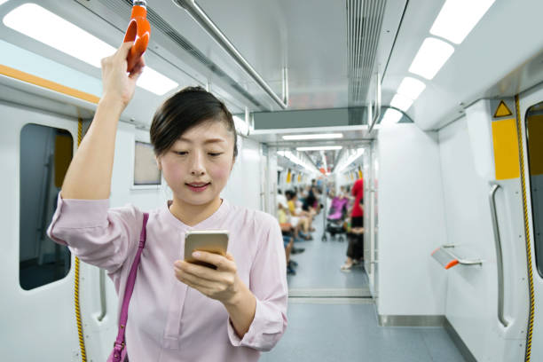 istock Woman using phone in the subway train 1183283912