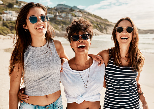 Shot of a group of happy young women enjoying a summer’s day at the beach