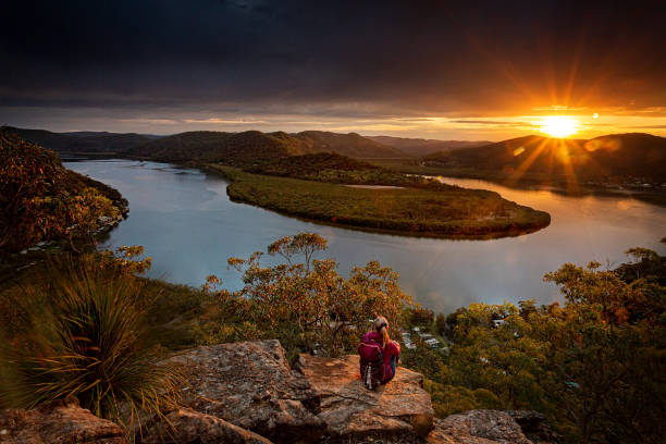 istock Sitting on a large boulder overlooking river horseshoe bend 1183284025