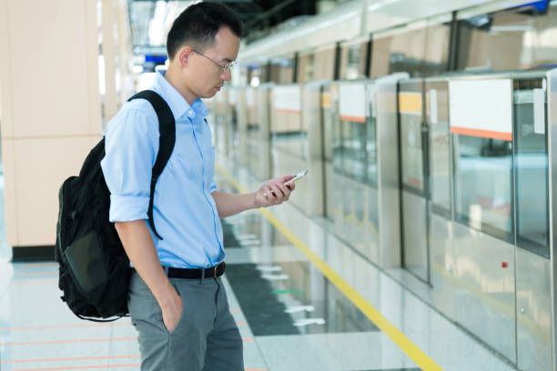 istock Businessman using smart phone at subway station 1183286151