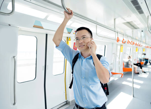 istock Businessman talking on the phone in the subway train 1183286172