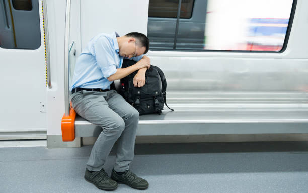 Tired businessman sleeping in subway train