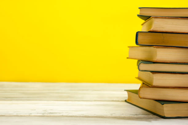 istock Open book, hardback books on wooden table. Back to school. Copy space 1183288267