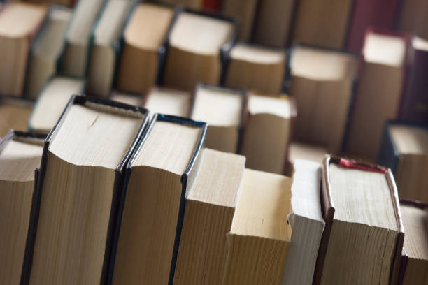istock Open book, hardback books on wooden table. Back to school. Copy space 1183288491