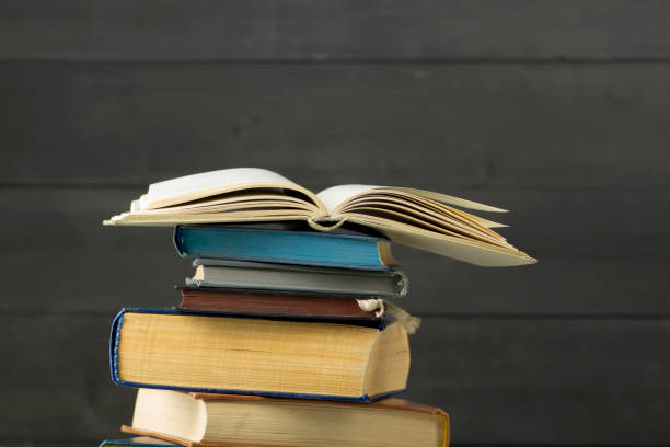 istock Open book, hardback books on wooden table. Back to school. Copy space 1183288530