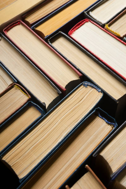 istock Open book, hardback books on wooden table. Back to school. Copy space 1183288598