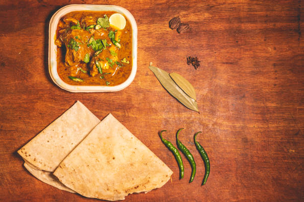 Slow cooked lamb stew. Mutton curry dish with thin Indian bread decorated with green chillies and Indian spices. hyderabad pakistan stock pictures, royalty-free photos & images