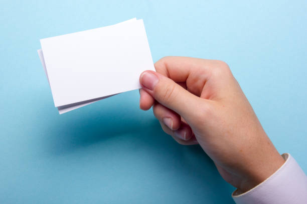 istock Hand holding white business card on white background 1183289787