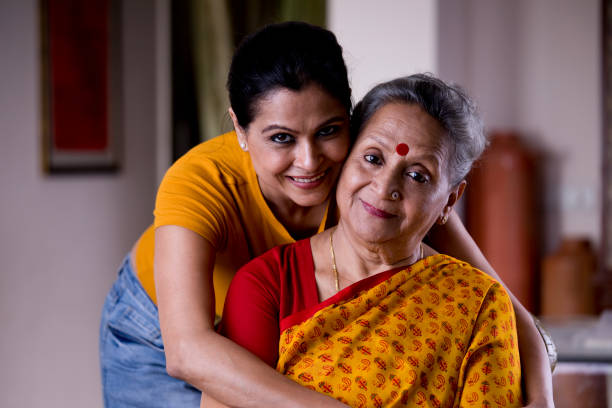 istock Woman embracing senior mother from behind 1183289976