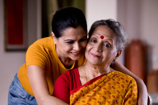 istock Woman embracing senior mother from behind 1183290919