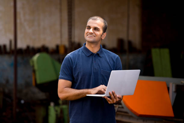 istock Male architect with laptop surveying the construction site 1183292154