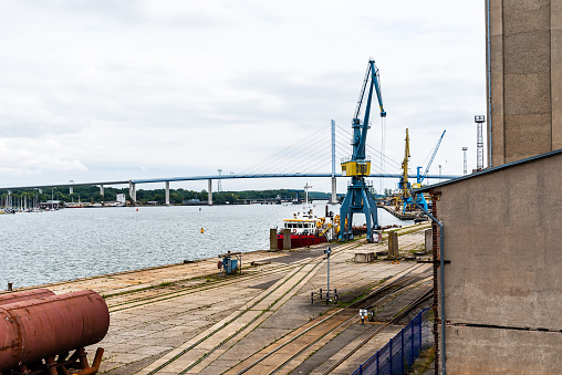 View of the commercial harbour of Stralsund with cranes and tugboat.