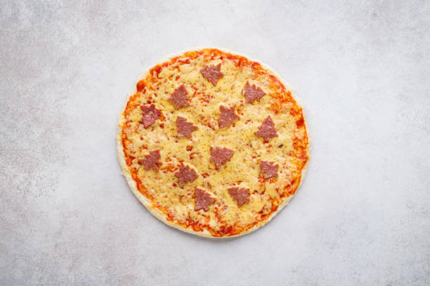 istock Pizza decorated with pepperoni shaped as Christmas trees. 1183295791