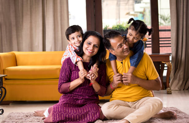 happy indian family at home - asian ethnicity child four people couple imagens e fotografias de stock