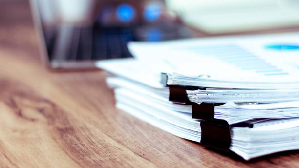 istock Stack of documents placed on a business desk in a business office. 1183298452