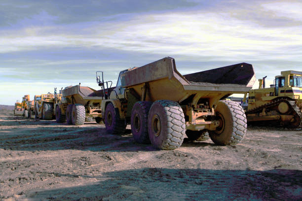 Heavy land moving equipment in Cochrane, Alberta, Canada Large vehicles awaiting use in land development cochrane alberta photos stock pictures, royalty-free photos & images