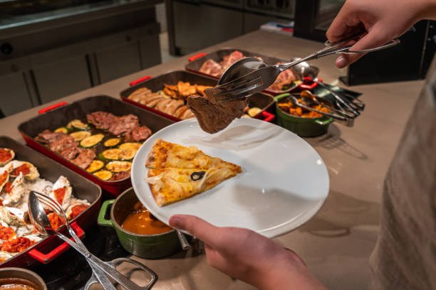 istock Asian man picking pizza and grilled meat in buffet meal 1183300916
