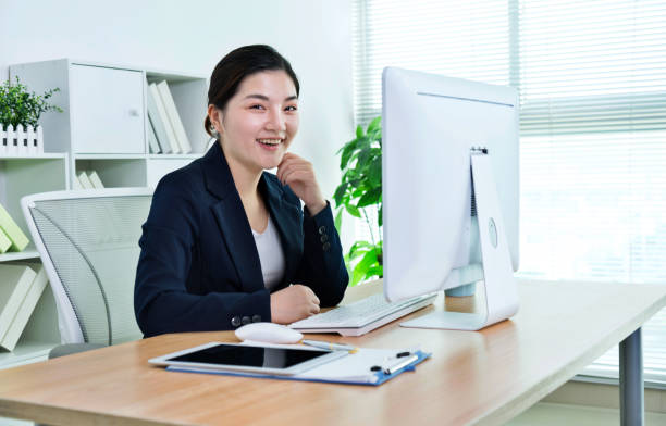 istock Smiling businesswoman working at her office 1183301881