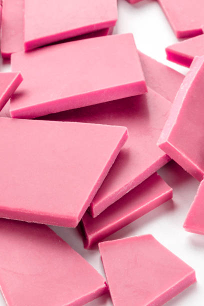 istock A close-up of ruby chocolate slices, a heap on a white background 1183303118